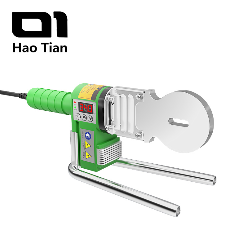 A Hao Tian brand handheld PPR pipe welding machine in green and silver. It features a green ergonomic handle, a digital temperature display with 'SET' and arrow buttons, and red/green indicator lights. The main heating plate is silver, with a circular heating die and an elongated slot for another die. Below the main body, there's a sturdy, U-shaped silver metal stand for stability. Various small safety labels are visible on the side of the green housing